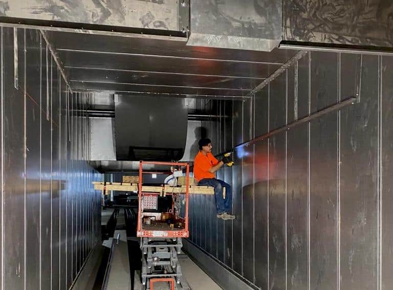 Wide-angle photo of contractors working on a project installation